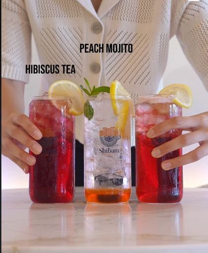 Reel still: hibiscus tea and peach mojito drinks at Shibam Coffee Co.