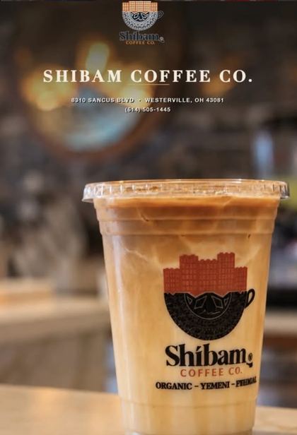 Iced latte in a Shibam Coffee Co. cup