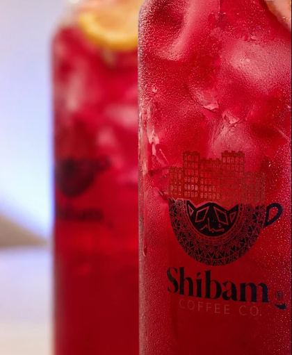 Iced red drinks in Shibam Coffee Co. cups